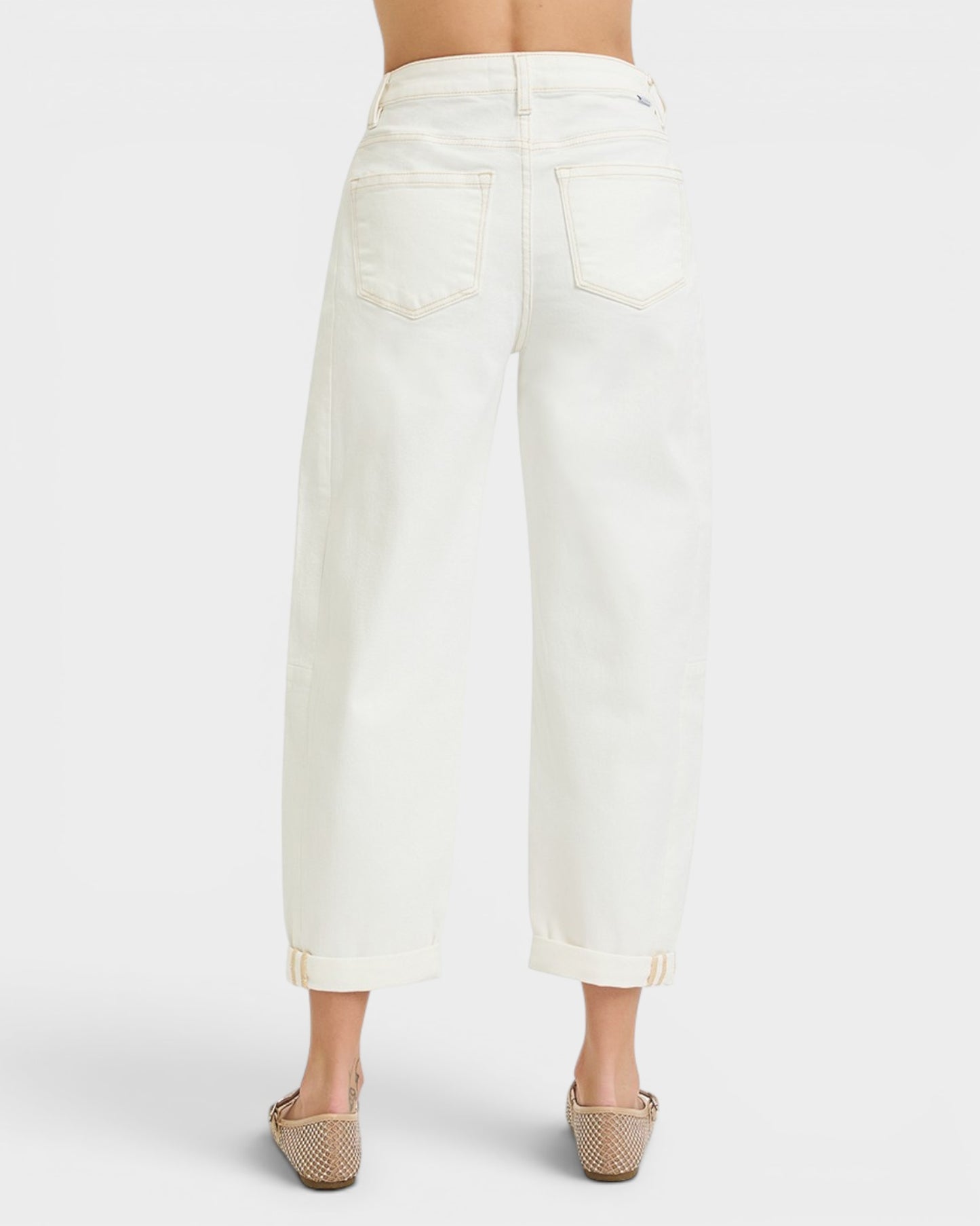 White denim skirt worn by a person on a white background