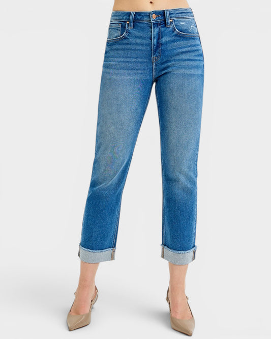 Blue jeans worn by a person on a white background