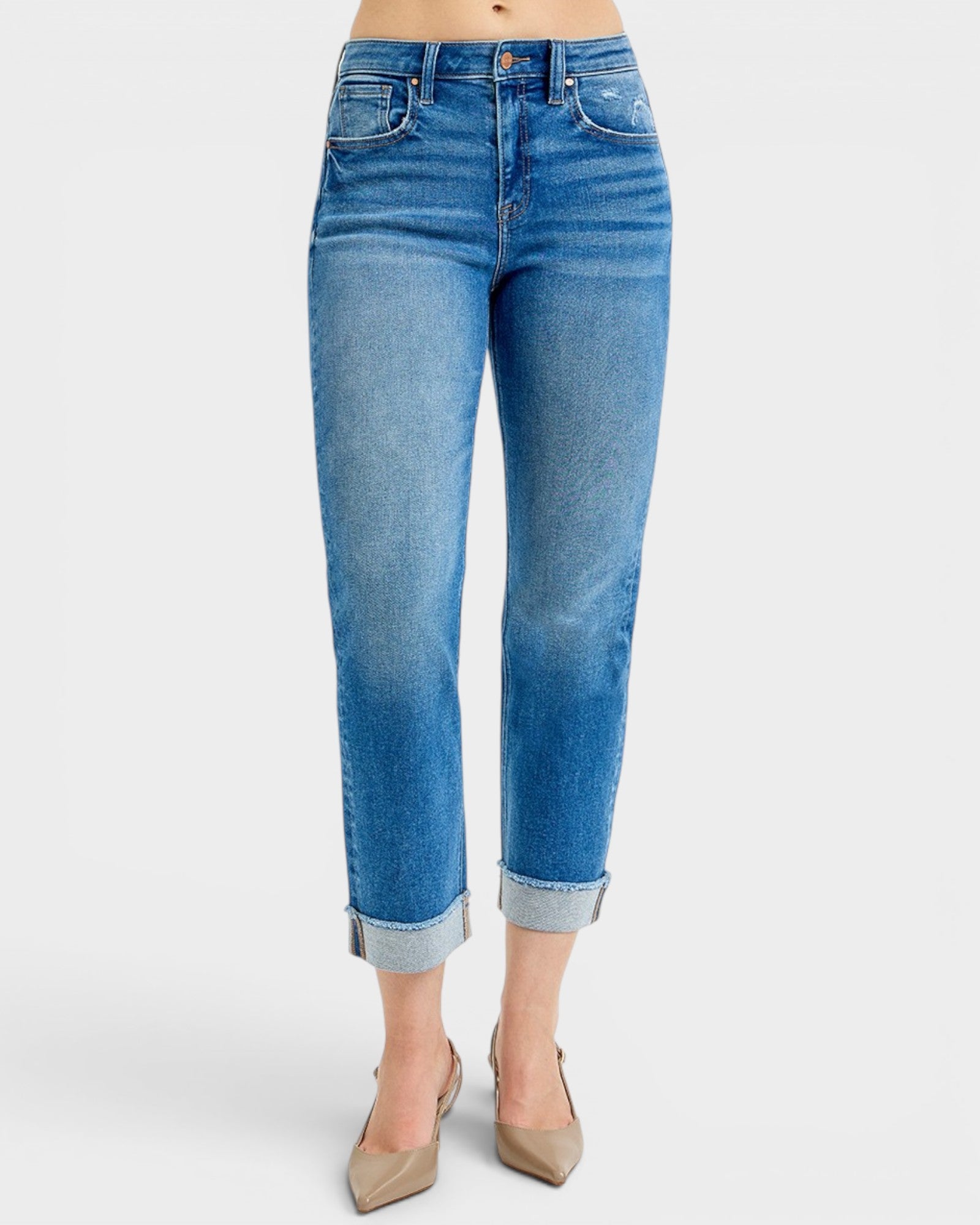 Blue jeans worn by a person on a white background