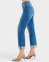 Blue jeans worn by a person on a white background