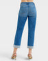 Blue jeans worn by a person on a white background