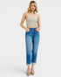 Woman wearing a strapless top and blue jeans on a white background