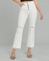 White distressed jeans worn by a person on a gray background