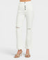 White high-waisted cropped jeans with a five-button fly and distressed rips at the knees, shown on a model wearing beige heeled sandals against a light gray background.