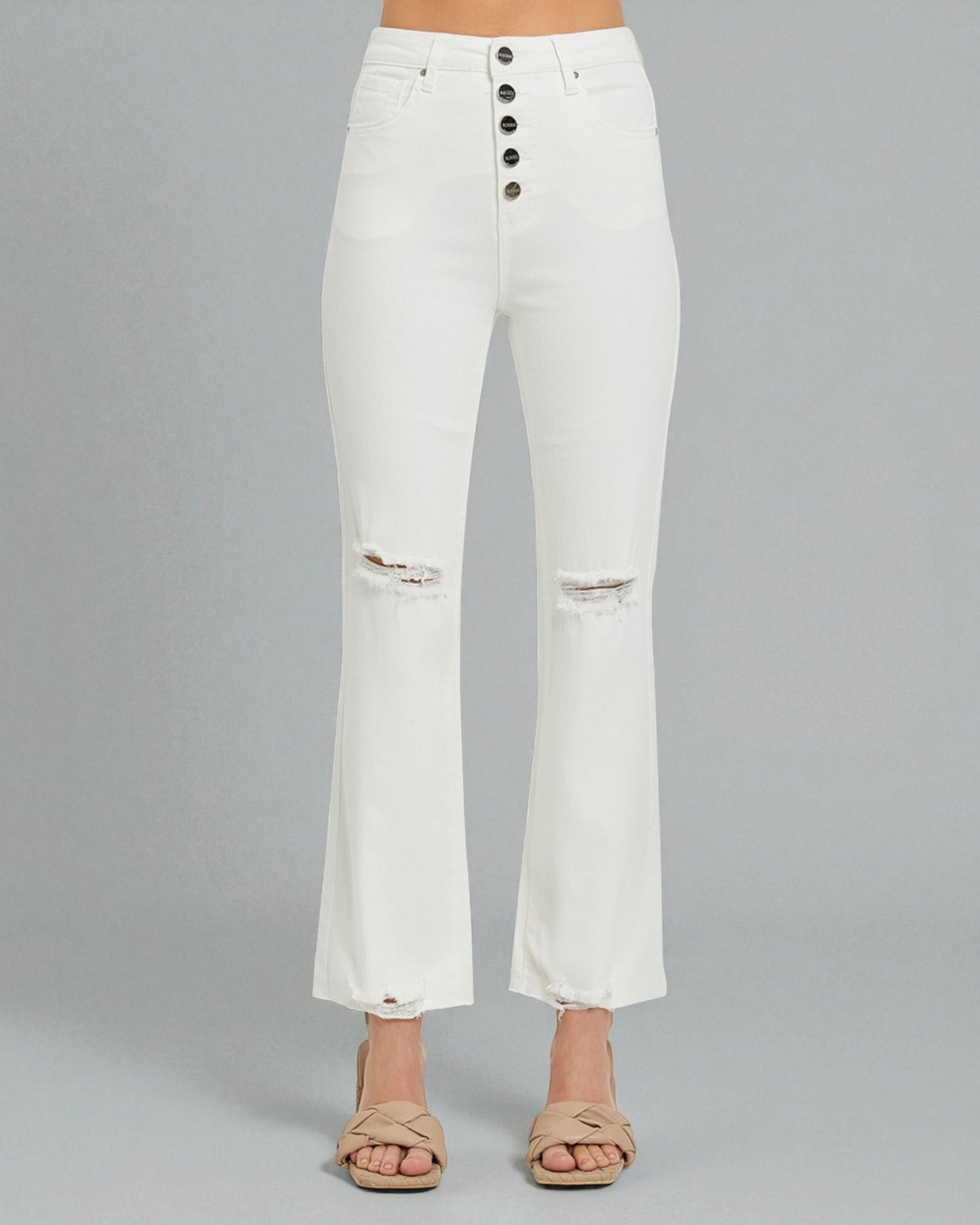 White distressed jeans on a gray background