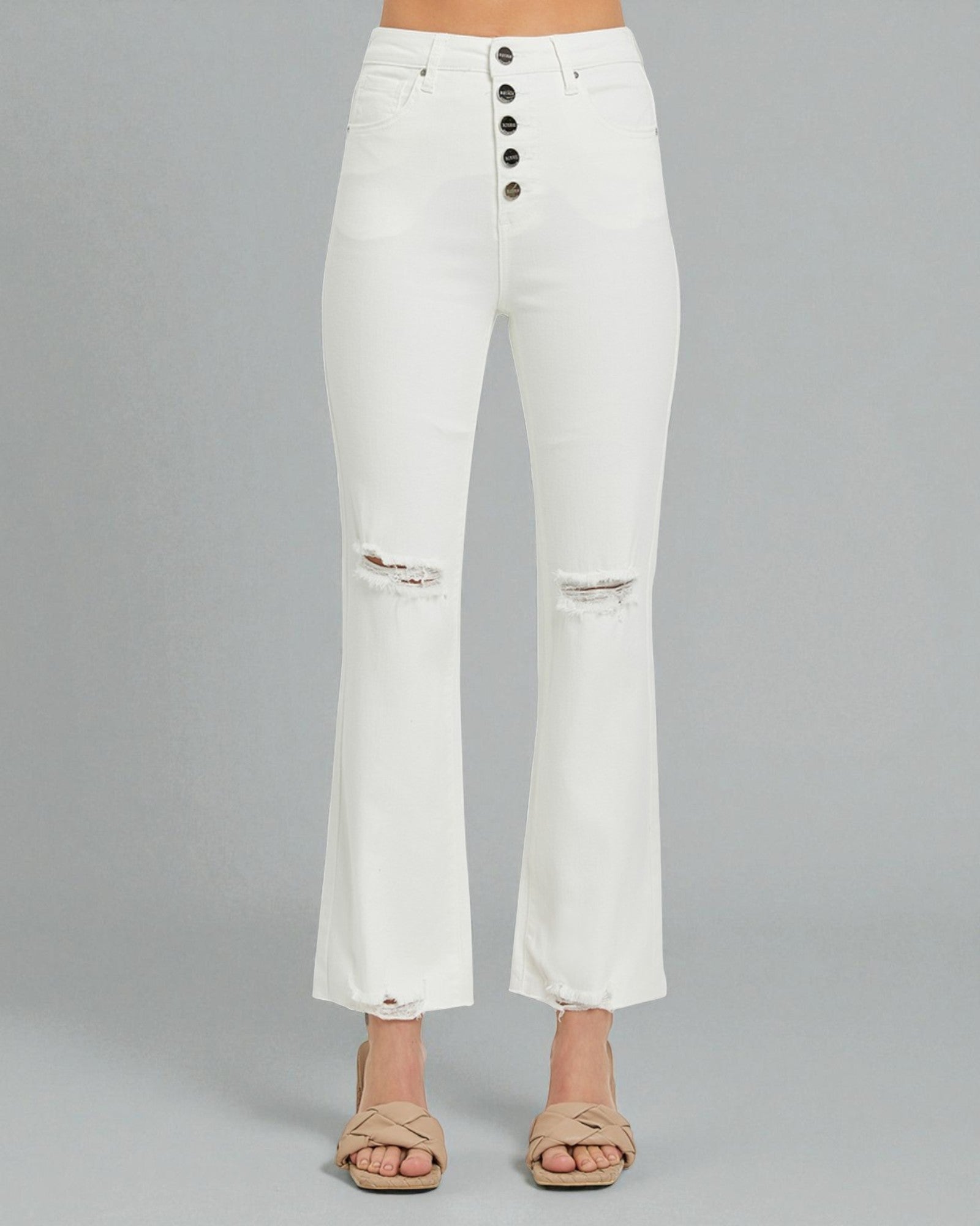 White distressed jeans on a gray background