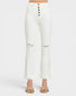 White high-waisted cropped flare jeans with a five-button closure and distressed knee details, shown on a model wearing beige sandals against a light gray background.