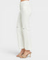 White cropped jeans with a high button-fly waist, distressed details on the thighs, and a raw frayed hem, shown on a model wearing beige heeled slide sandals against a light gray background.