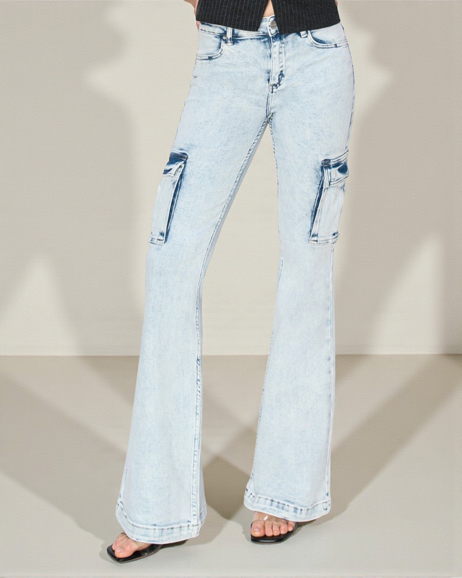 Light blue flared jeans on a neutral background
