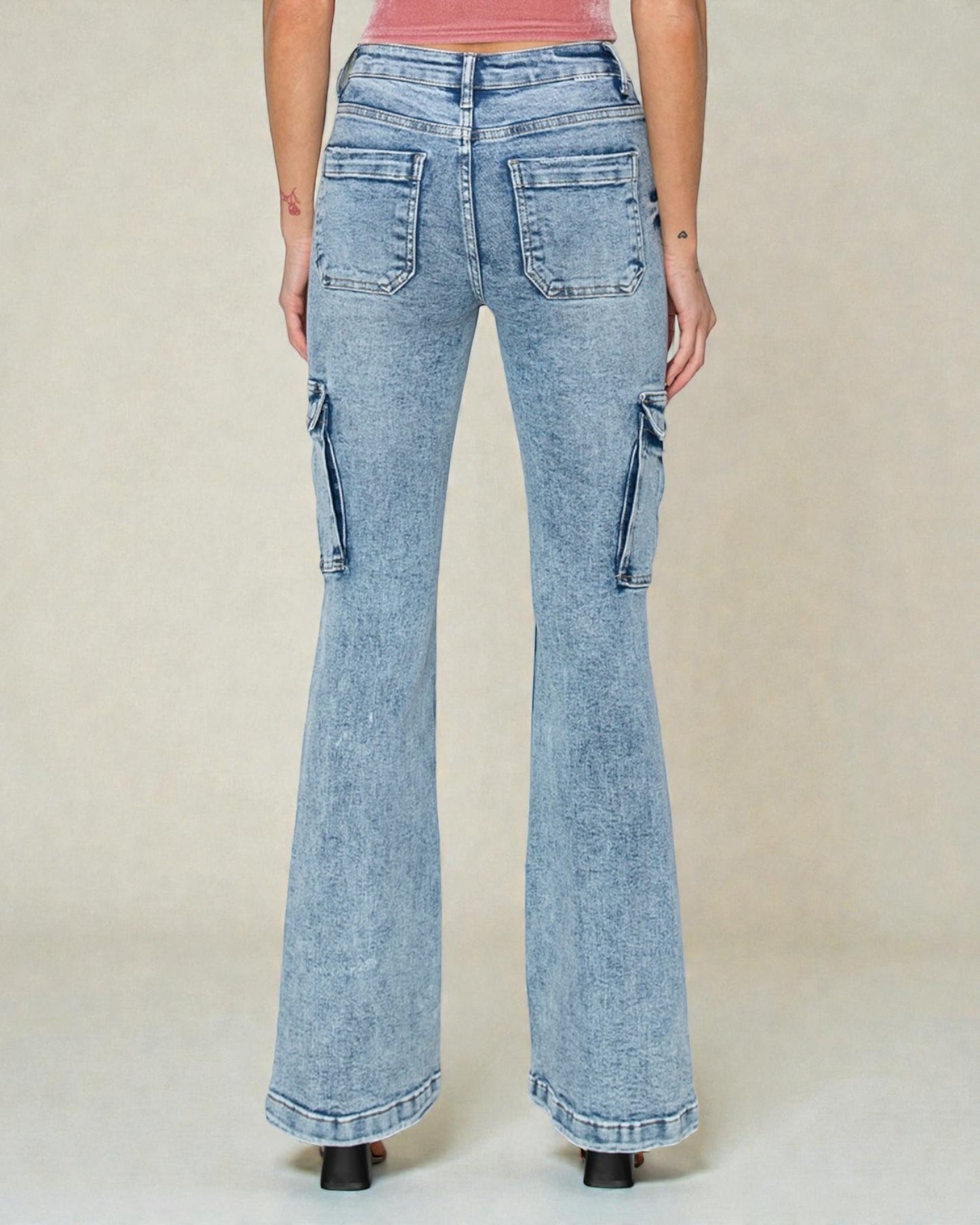 Light blue flared jeans worn by a person on a plain background