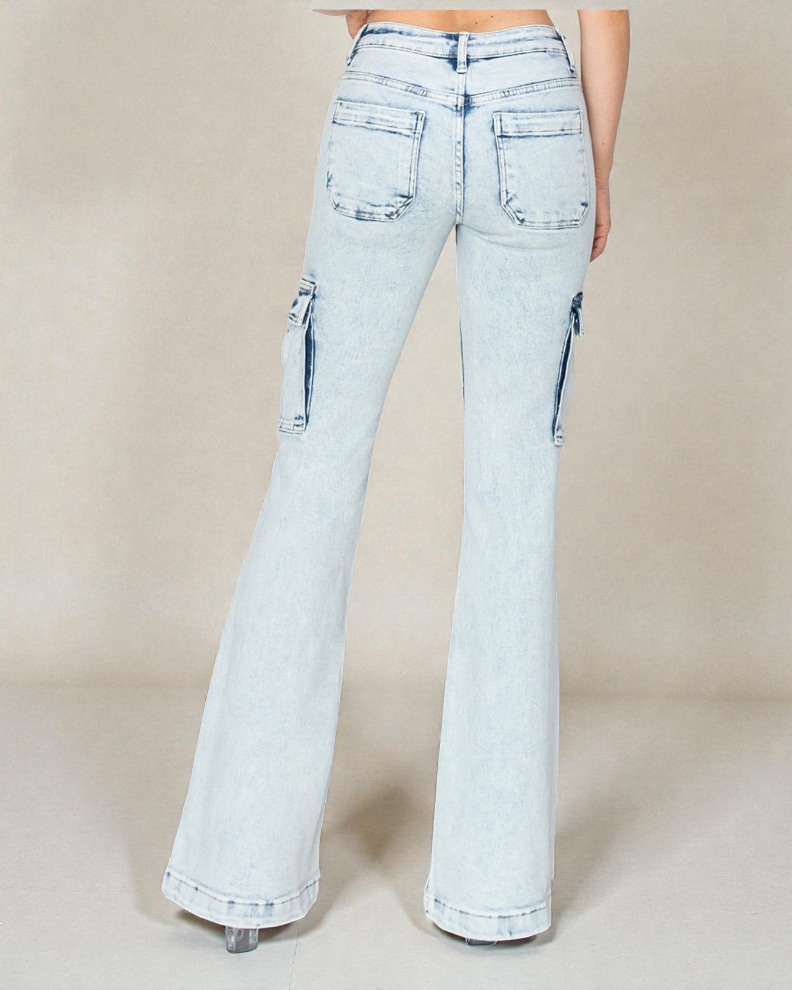 Light blue flared jeans on a beige background