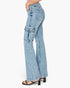 A side profile view of a model wearing high-waisted, light blue denim flare jeans with cargo pockets on the thighs, paired with black heeled sandals against a plain white background.