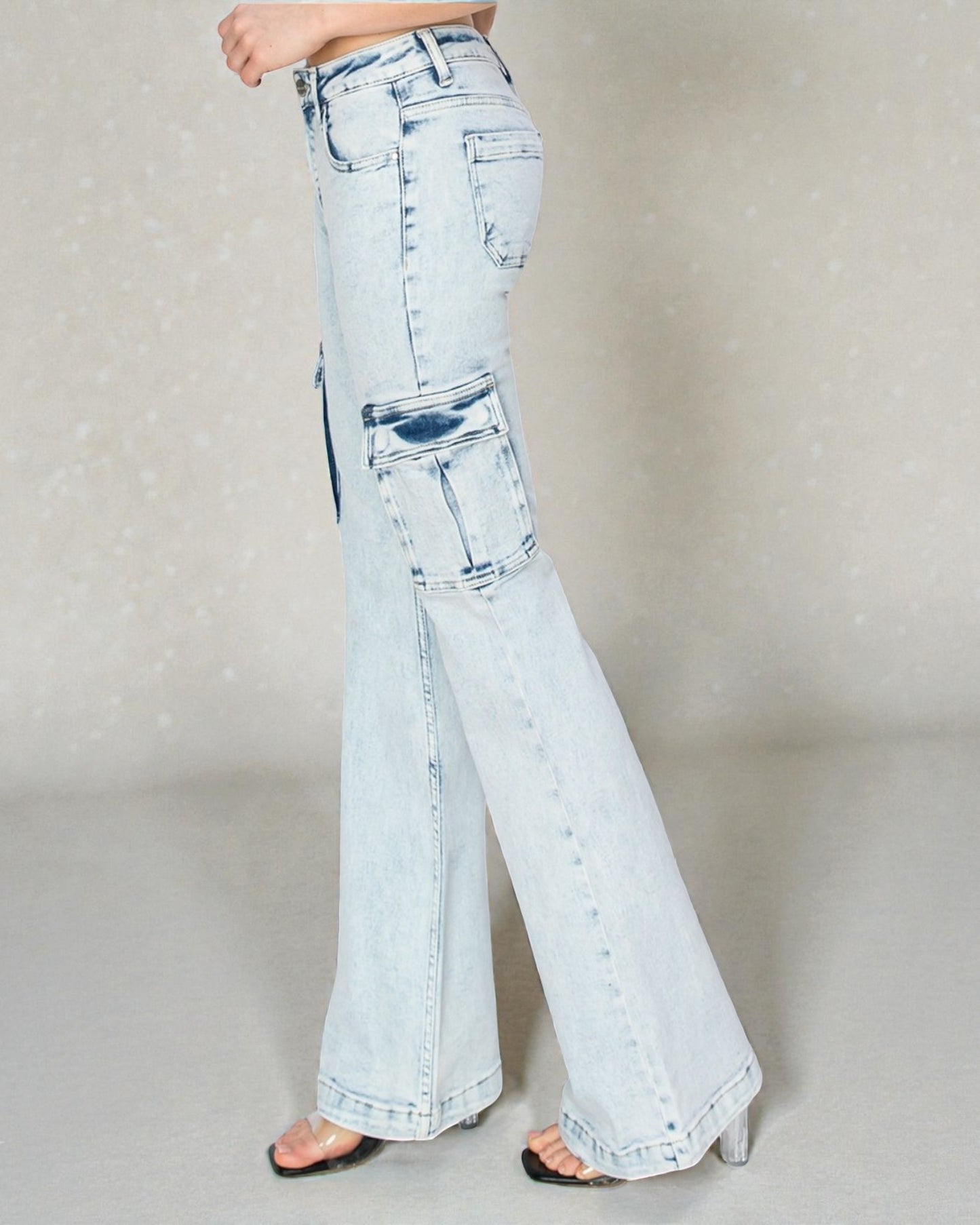 Light blue flared jeans worn by a person on a neutral background