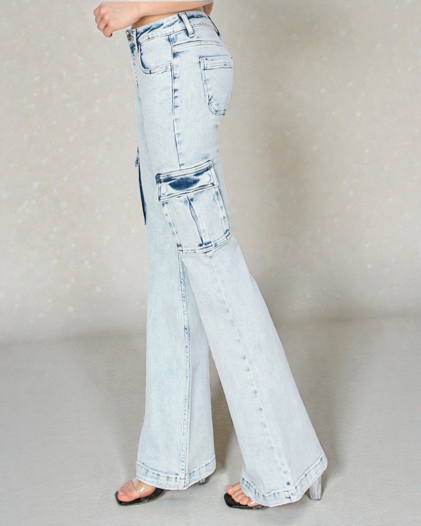 Light blue flared jeans worn by a person on a neutral background