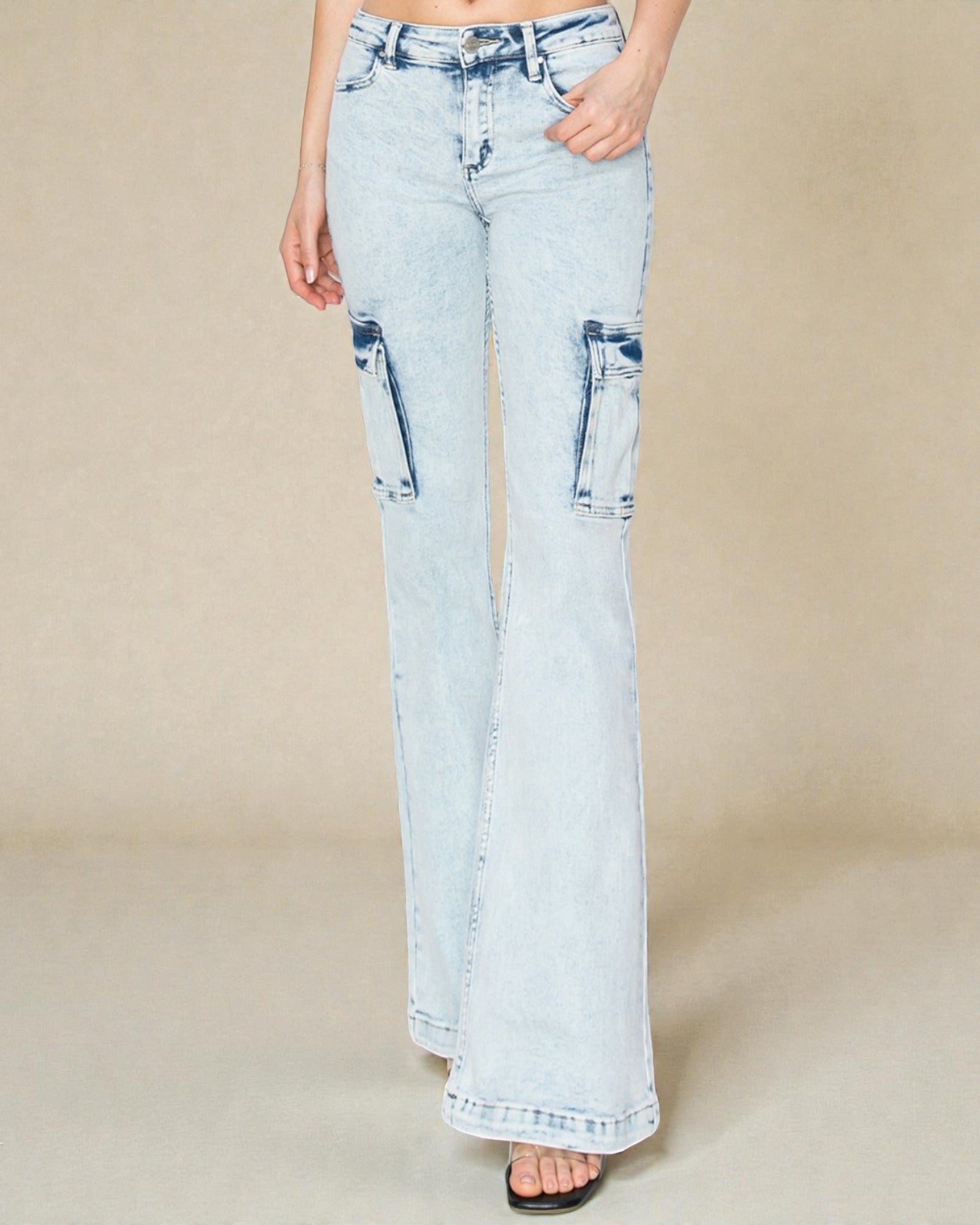 Light blue jeans worn by a person on a beige background