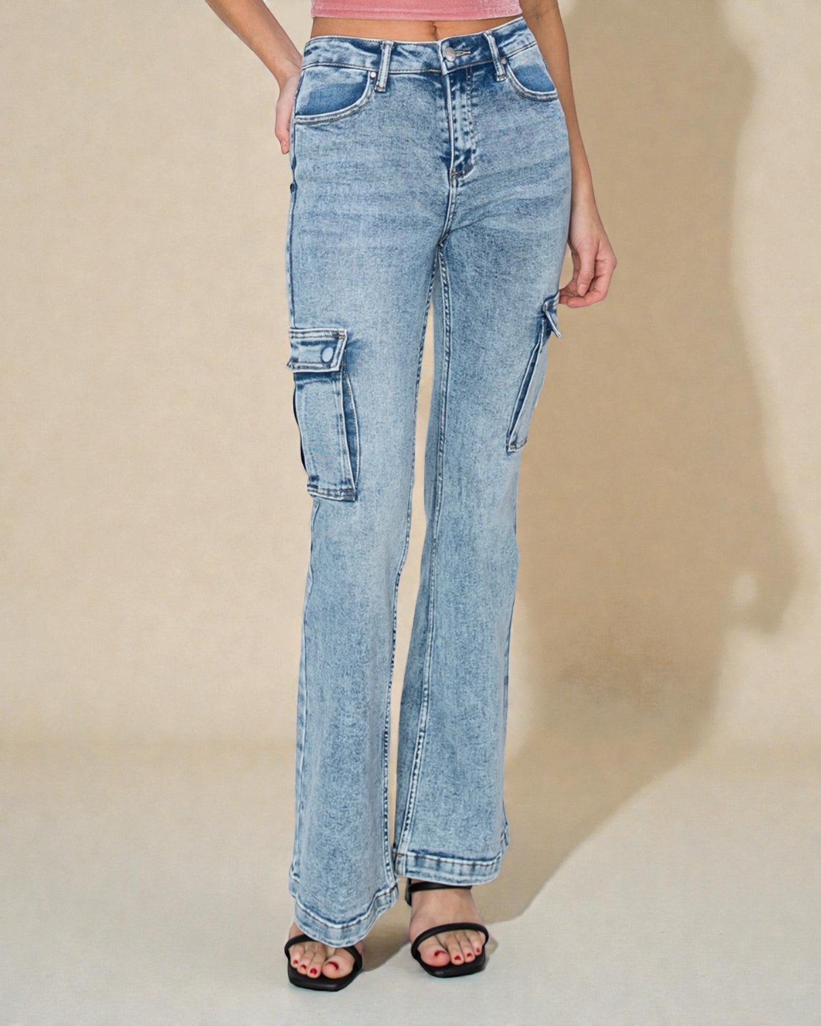 Light blue jeans worn by a person on a beige background