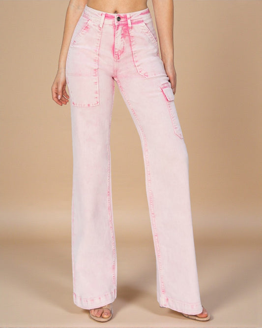 Pink acid-wash jeans worn by a person on a beige background