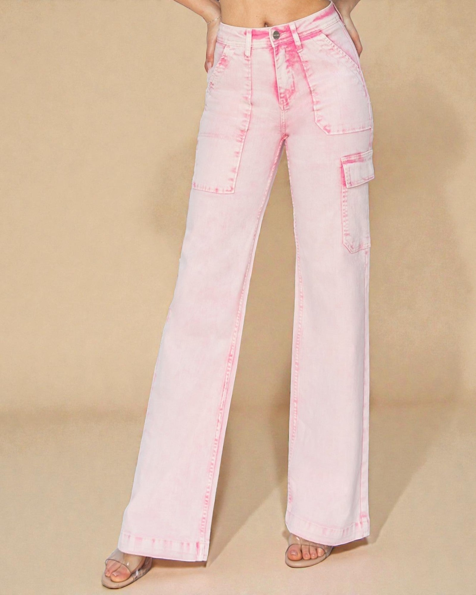 Pink jeans worn by a person on a beige background