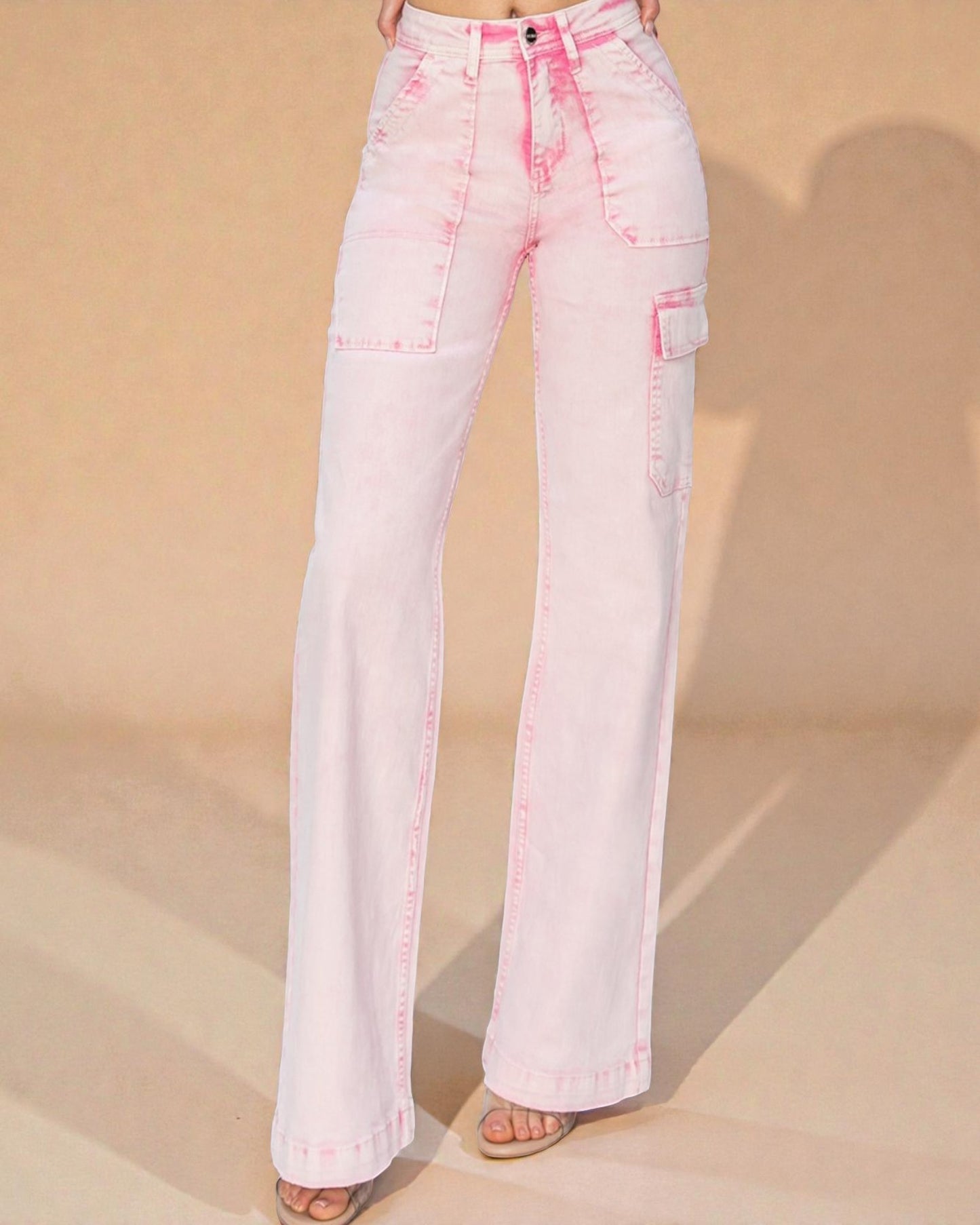 Pink flared jeans on a beige background
