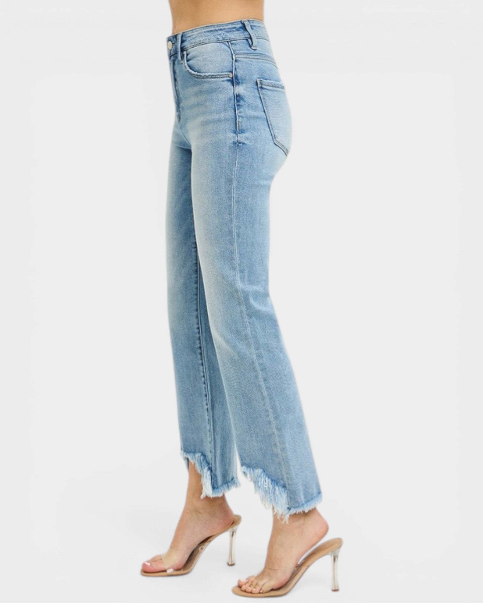 Light blue jeans worn by a person on a white background