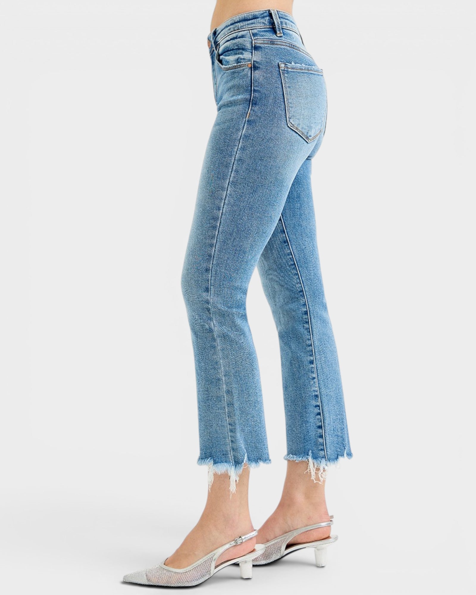 Light blue jeans worn by a person on a white background