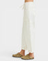 Person wearing white pants and brown shoes on a white background