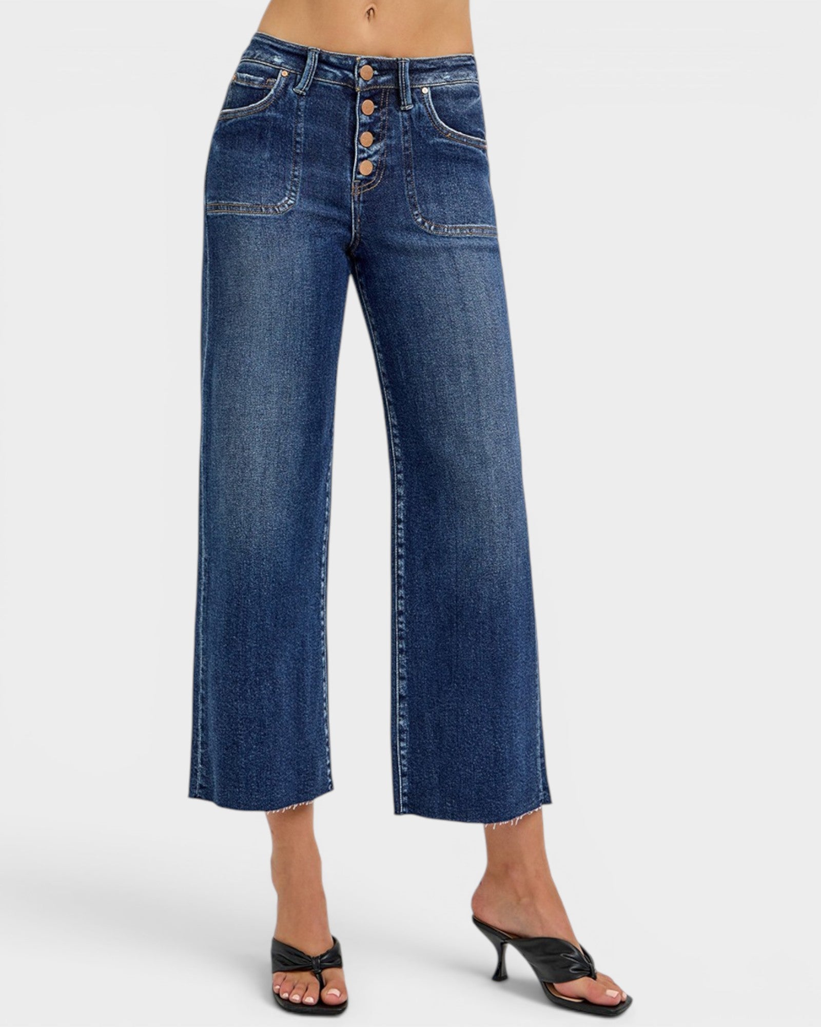Blue jeans worn by a person on a white background