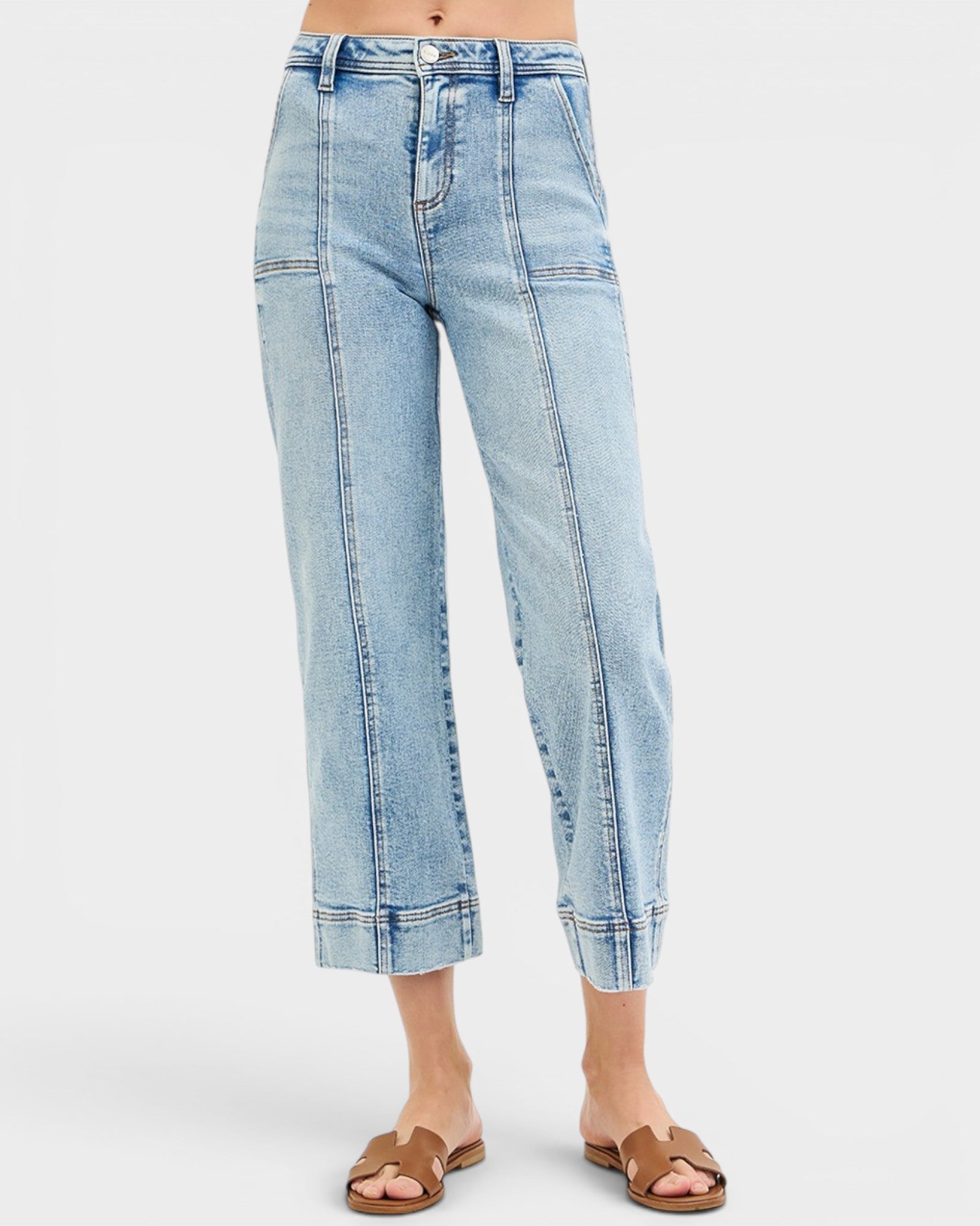 Light blue jeans worn by a person on a white background