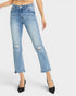 A model wearing light-wash blue cropped jeans with distressed rips on the thighs and knees, paired with black pointed-toe heels against a light gray studio background.