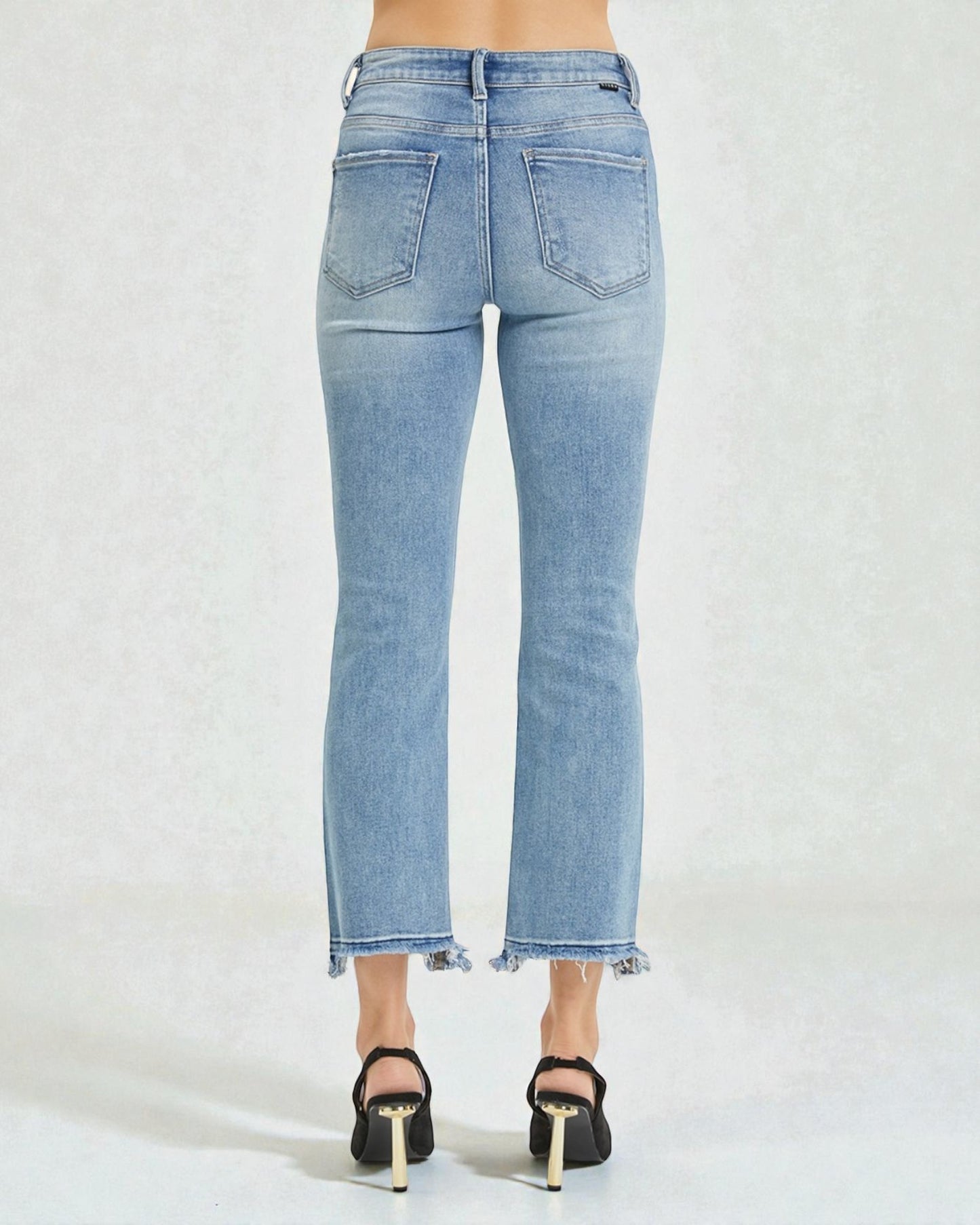 Light blue jeans worn by a person on a white background