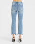 Back view of a model wearing light blue cropped flare jeans with a frayed hem and black high heels against a light gray studio background.