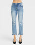 Light wash blue cropped jeans with distressed knee details and frayed hems, shown on a model wearing black pointed-toe heels against a light gray studio background.