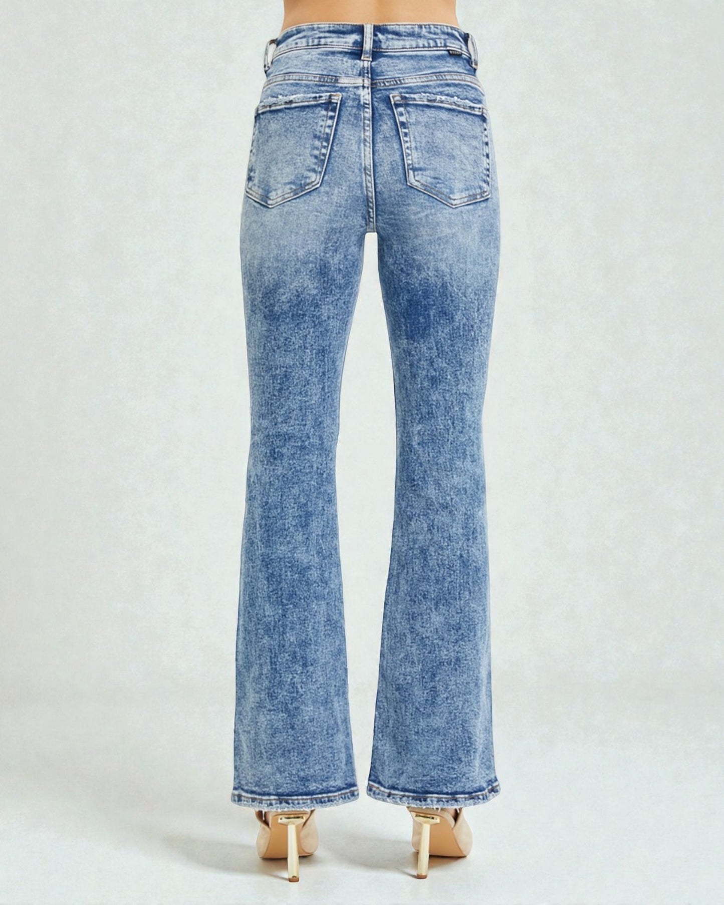 Light blue flared jeans on a white background