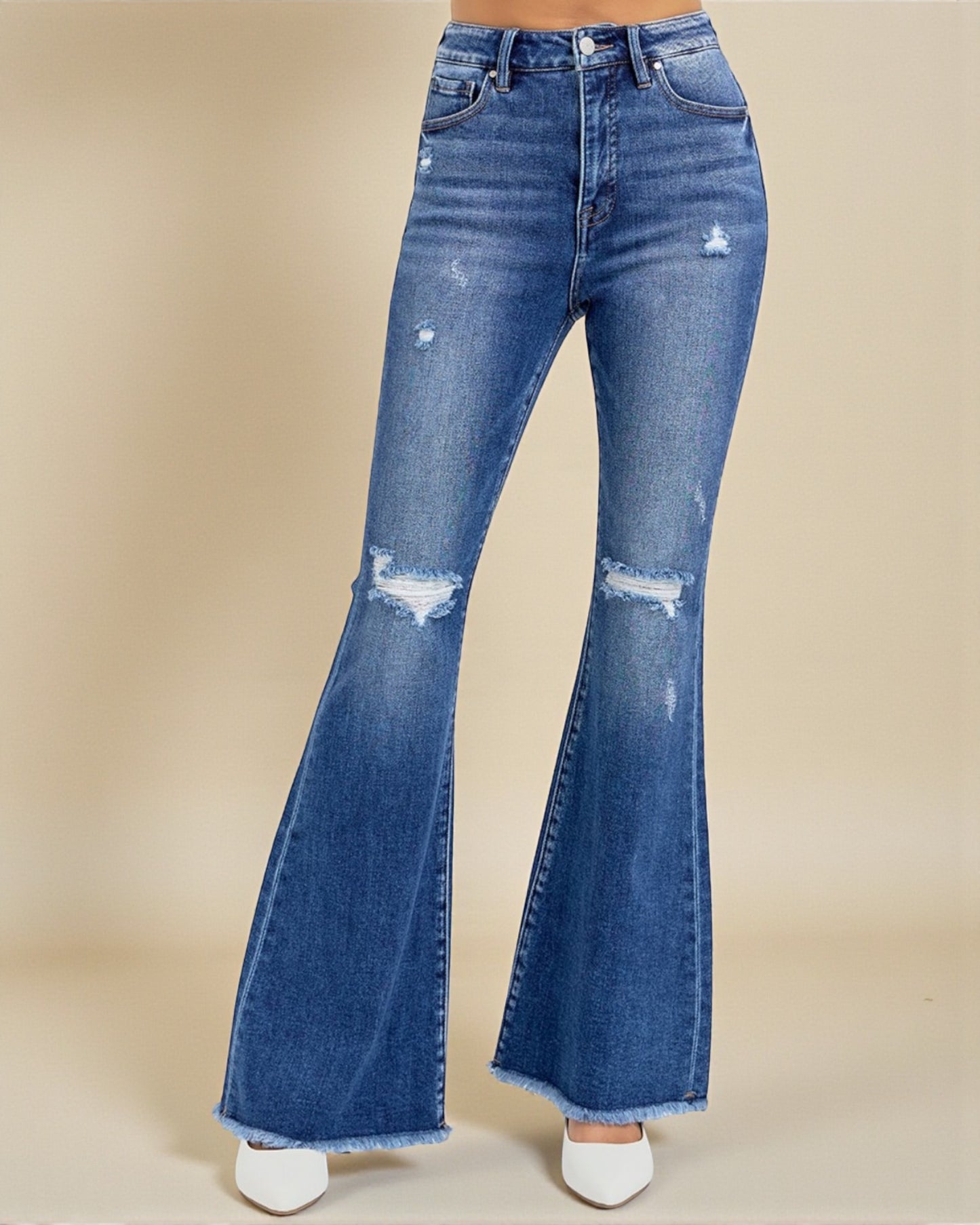 Blue flared jeans on a beige background