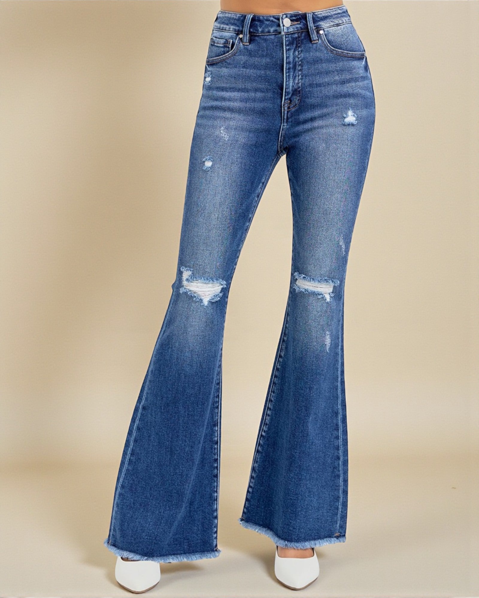 Blue flared jeans on a beige background