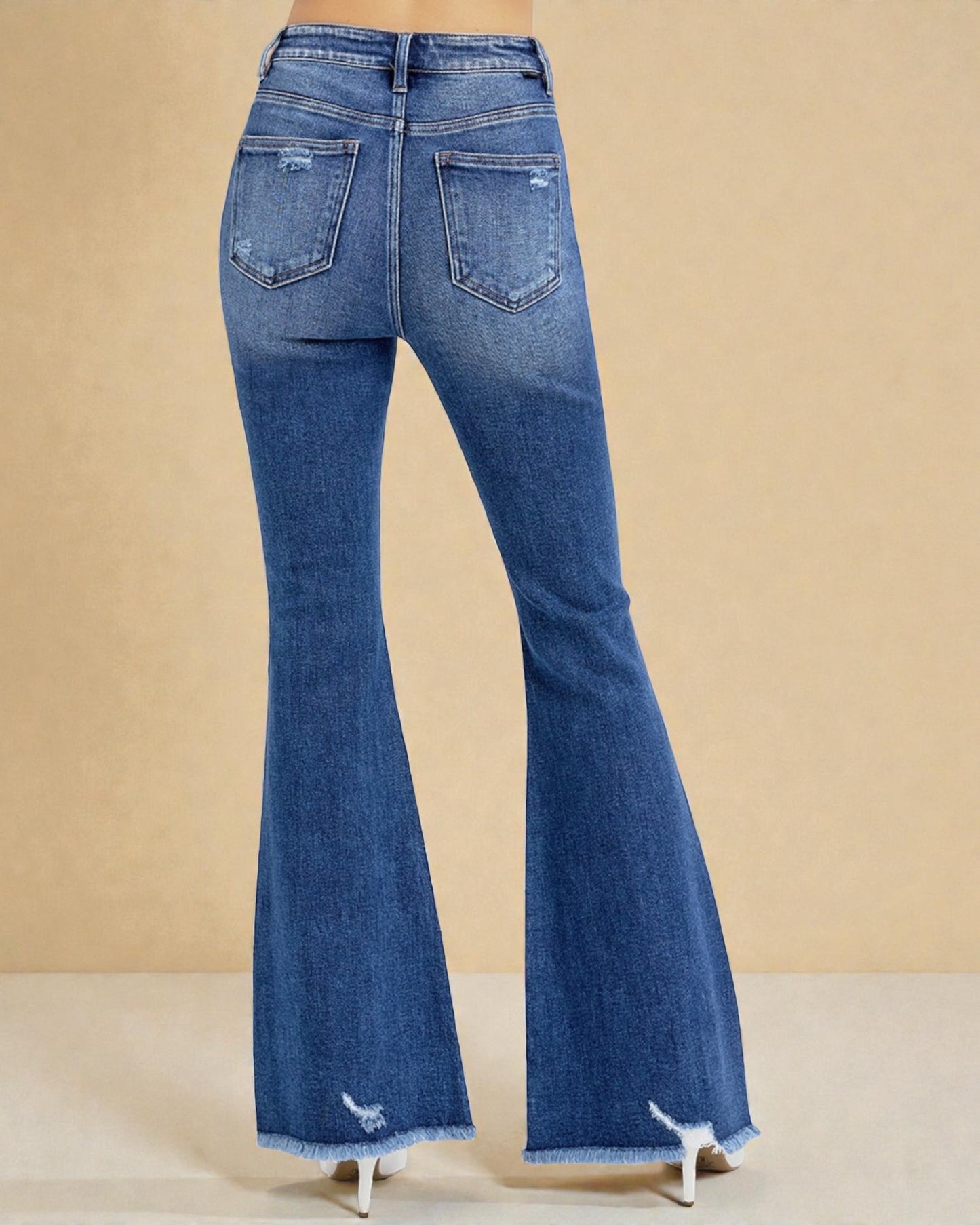 Blue flared jeans on a beige background