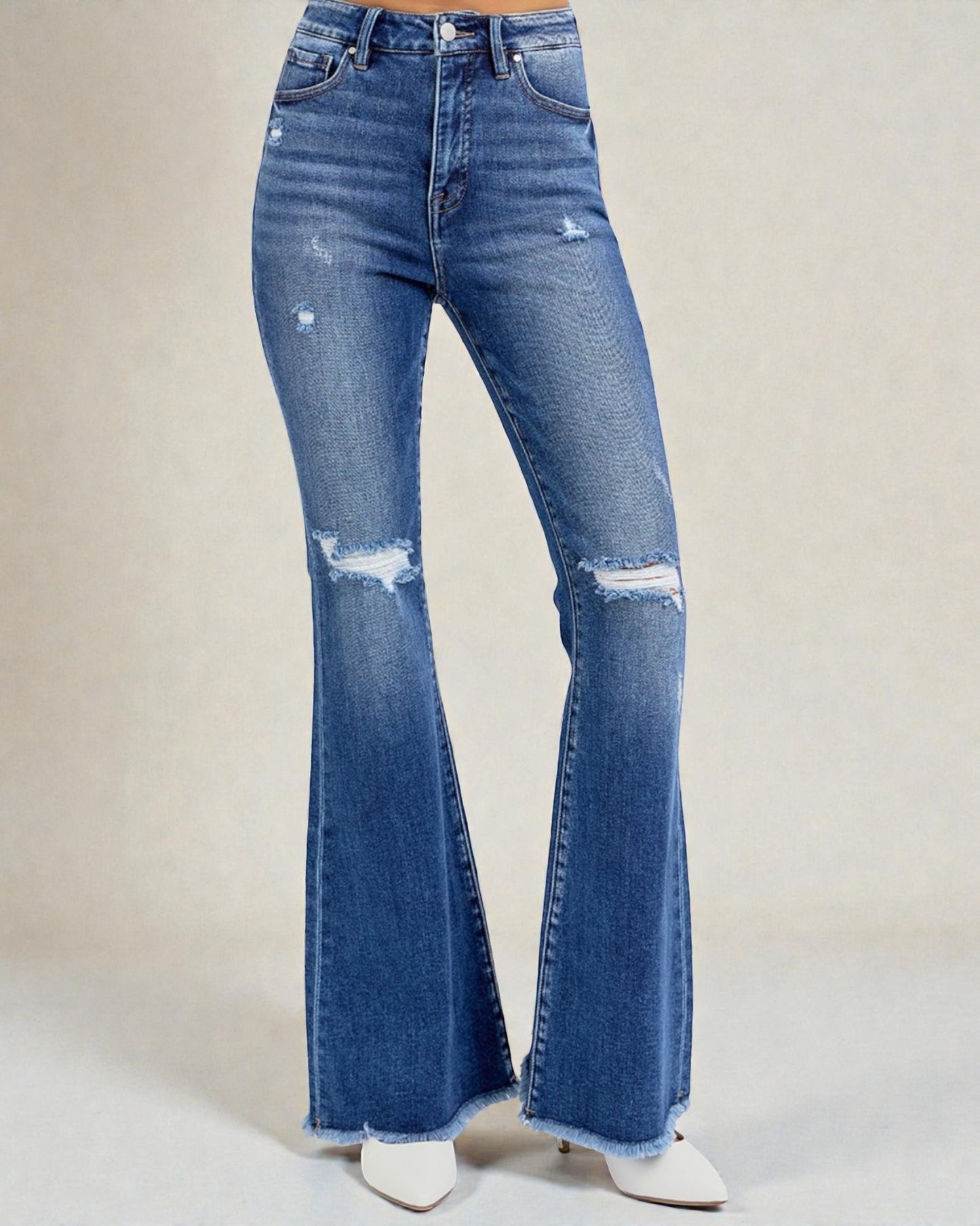 Blue flared jeans on a plain background