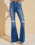 Blue flared jeans worn by a person on a beige background