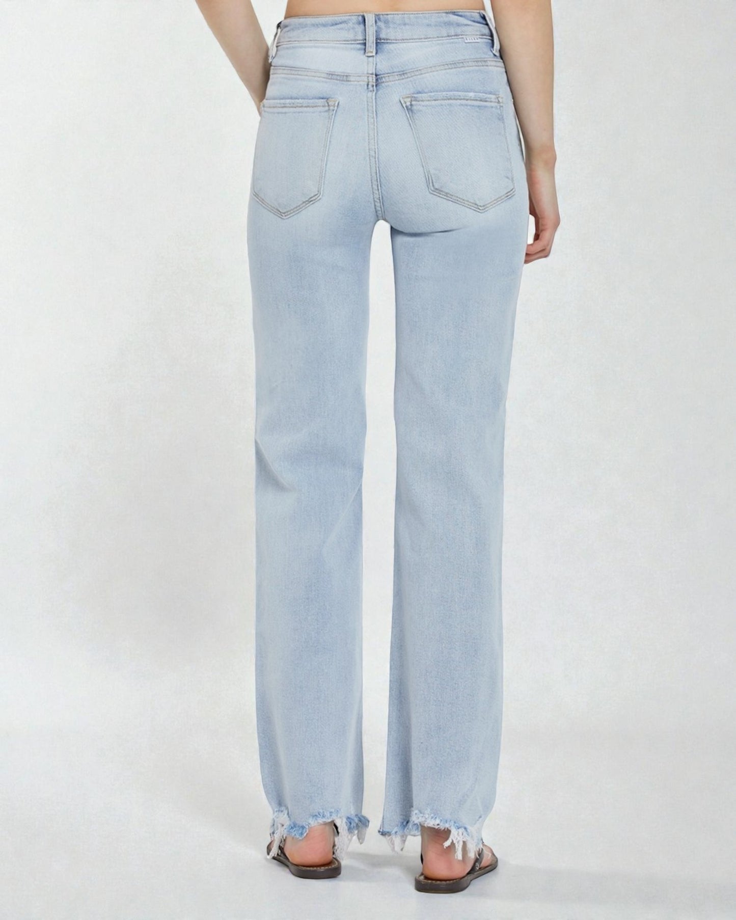 Light blue jeans worn by a person on a white background