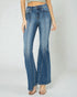 Blue flared jeans worn by a person on a white background