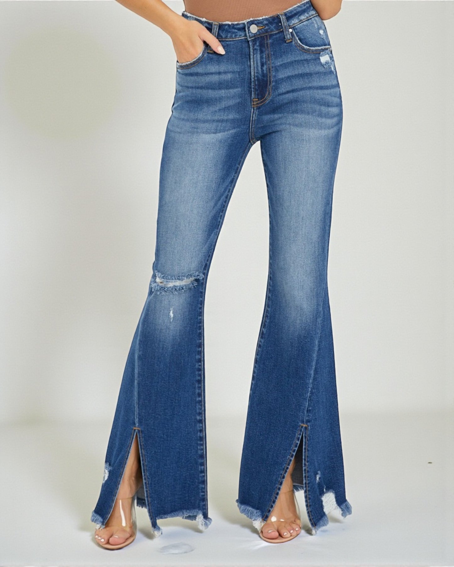 Blue flared jeans with a high slit on a light gray background