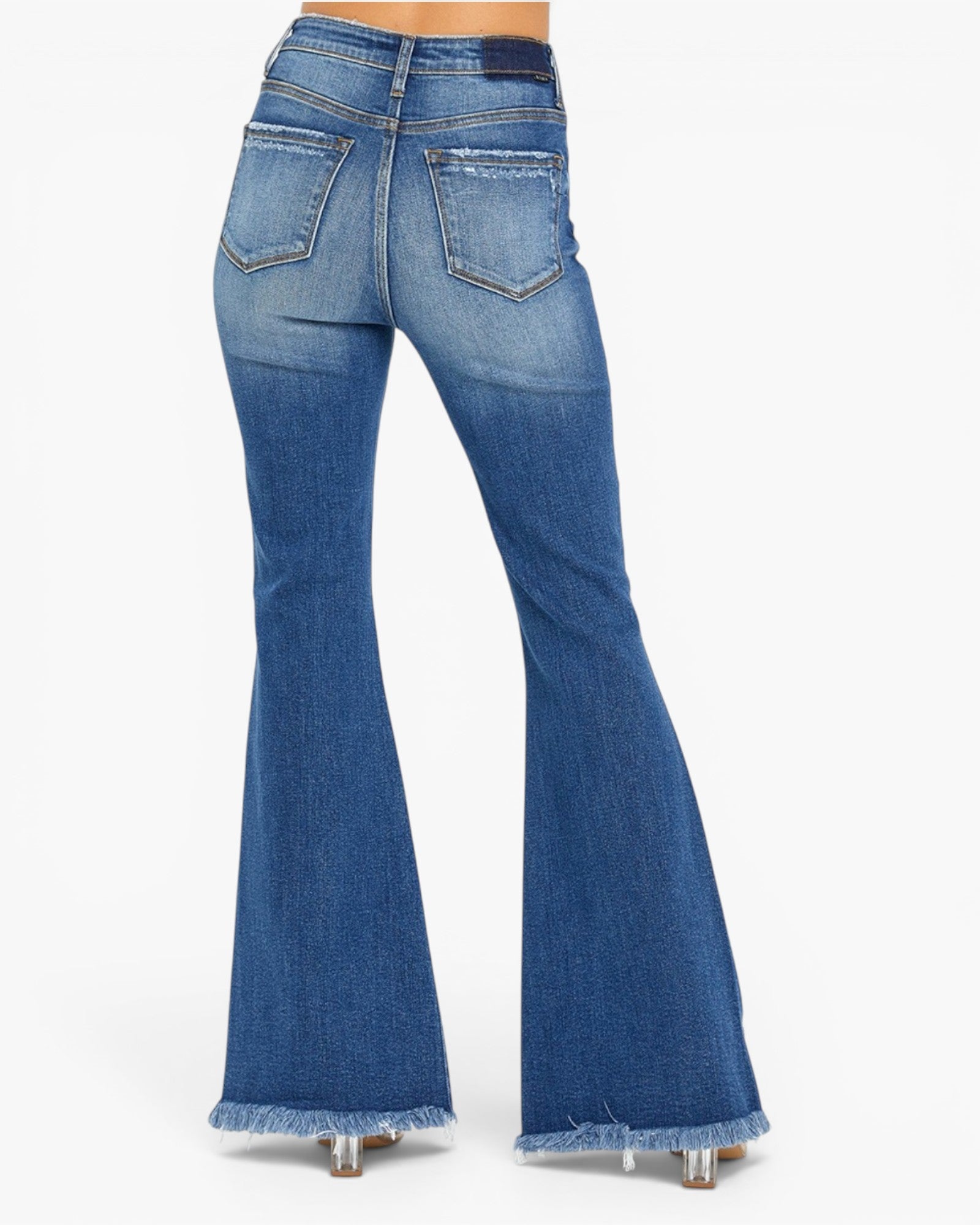 Blue denim flare jeans shown from the back, featuring a frayed hem and back pocket details, modeled on a white background.