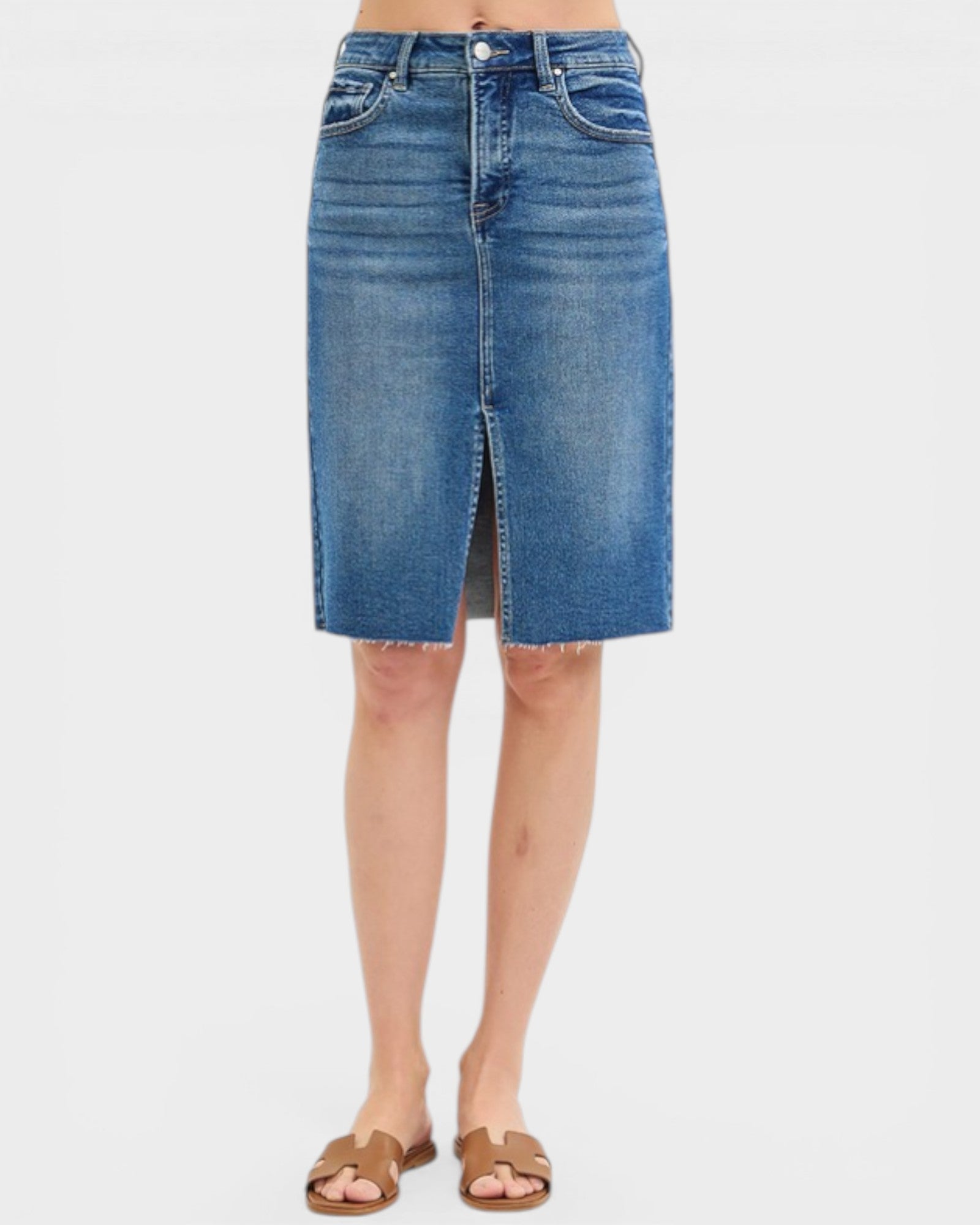 Blue denim skirt worn by a person on a white background