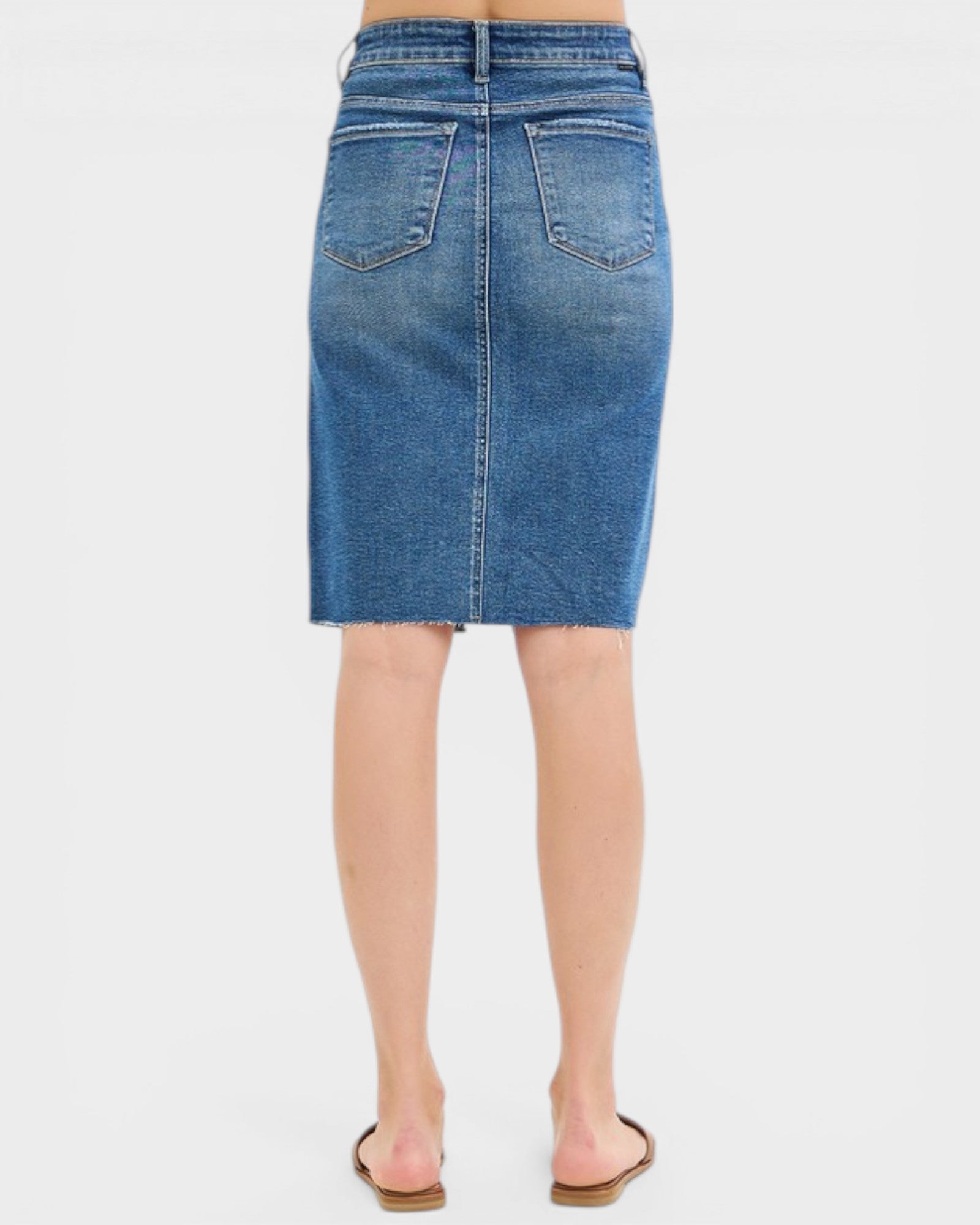 Blue denim skirt worn by a person on a white background