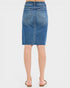 Blue denim skirt worn by a person on a white background
