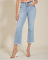 Light blue jeans worn by a person on a beige background
