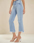 Light blue jeans worn by a person on a beige background