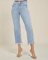 Light blue jeans worn by a person on a beige background