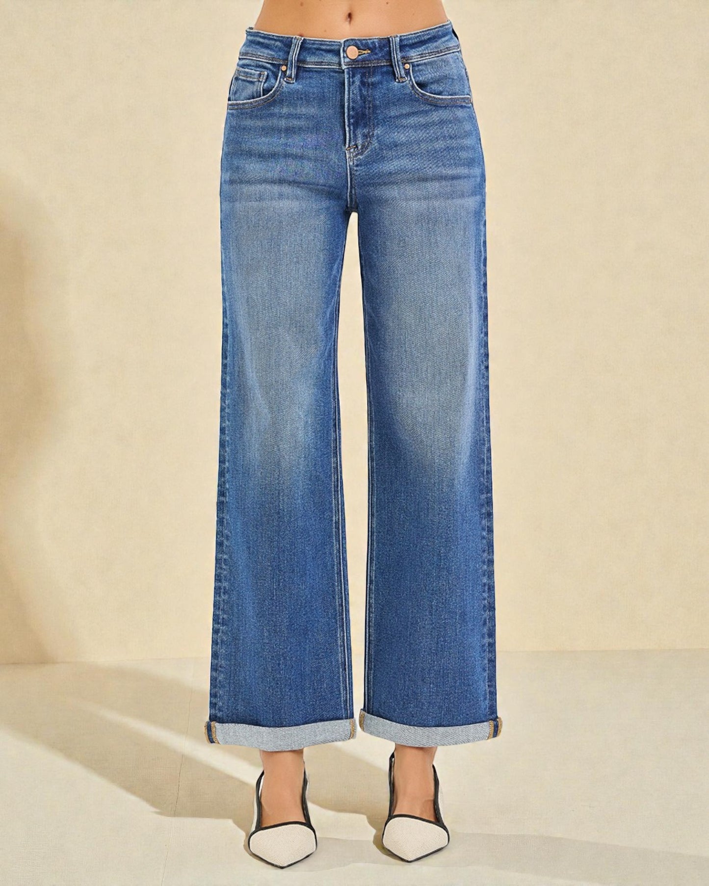 Blue wide-leg jeans on a neutral background