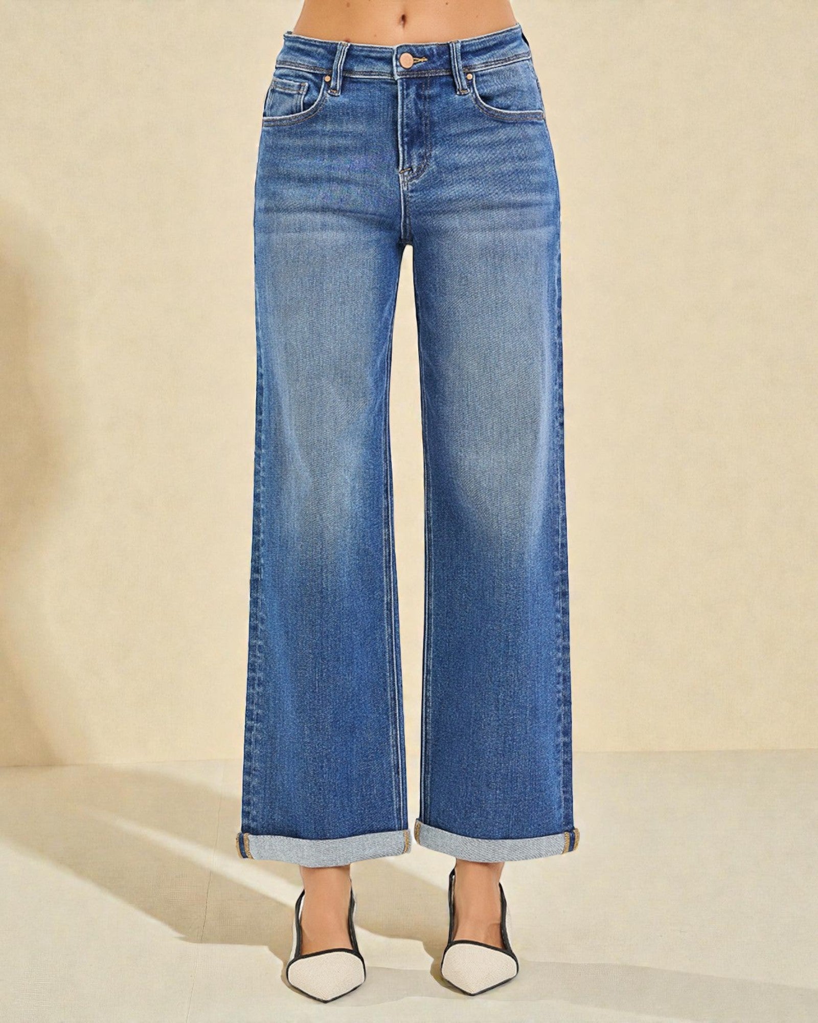 Blue wide-leg jeans on a neutral background